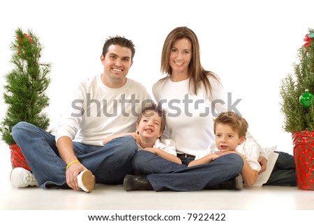 Happy young family posing for their cheerful holiday portrait