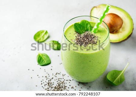 Vegetarian healthy green smoothie from avocado, spinach leaves, apple and chia seeds on gray concrete background. Selective focus. Space for text. Royalty-Free Stock Photo #792248107