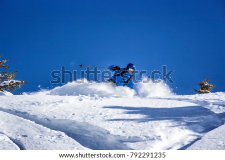 Freerider skiing through fresh powder