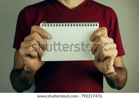 Hands holding paper blank