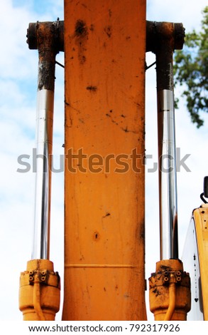 hydraulic system to working excavator on a blue sky background. Russia. Reportage shooting.