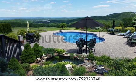 The #1 Classic Money Shot: Summer Panoramic Scene with Outdoor Pool and Patio, Koi Pond & Long Distance Views of Rolling Hills; Speaks Wealth, Lifestyle, Accomplishment, Vacation/Villas, Summer Ready Royalty-Free Stock Photo #792323740