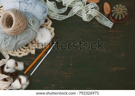 thread for crocheting, hook, lace on a dark background. Place for text, handmade