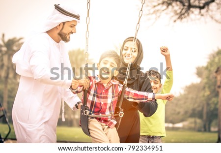 Arabian family portrait in the park Royalty-Free Stock Photo #792334951