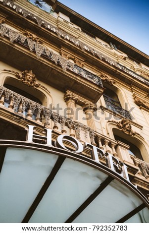 Majestic hotel word with white big letters on luxury awning and luxurious balconies facade 