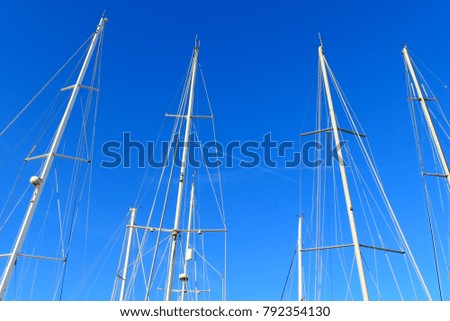 Sailing boat poles against blue sky background – 
City of Vittoriosa / Mediterranean island and republic of Malta.
