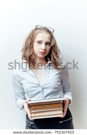 cute girl teacher at the blackboard on a white background smiling, live emotions