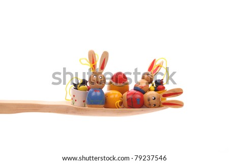 Easter stuff simply offered on a wooden spoon isolated on a white background