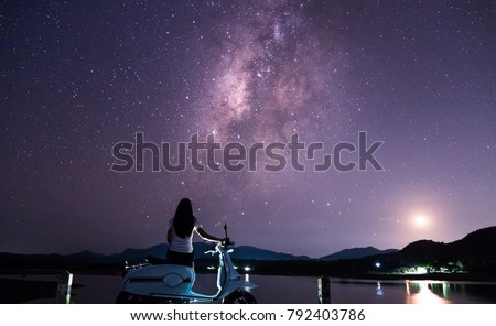 Lovers are happy in the night with the Milky Way and stars in the beautiful night sky.