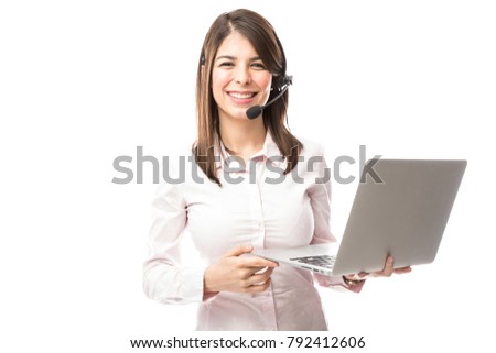 Cute and nerdy young woman with a laptop computer working as a tech support rep in a call center