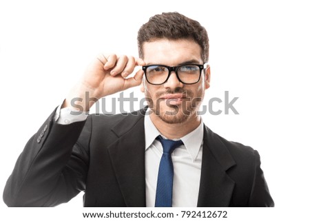 Attractive young Latin businessman looking confident while wearing glasses