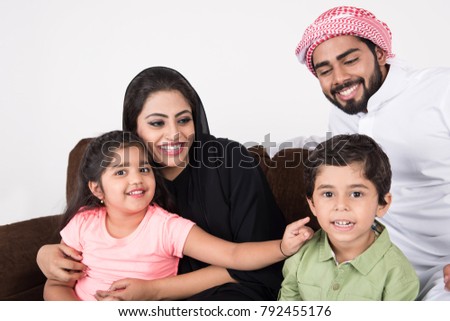 Arab family sitting on sofa chair at home enjoying the time with white background