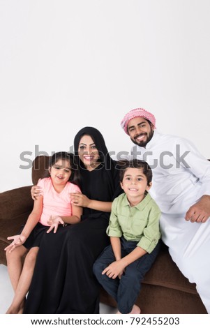 Arab family sitting on sofa chair at home enjoying the time with white background