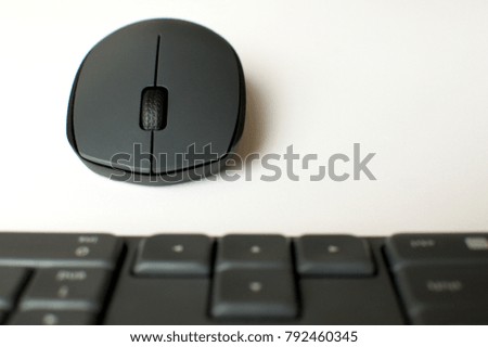 A gray wireless mouse and a keyboard