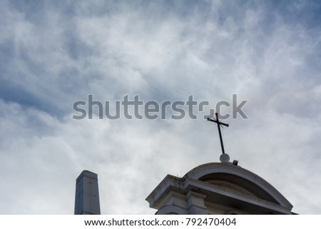 View From Down To Up Of a Cross On a Partially Cloudy Sky Background. Taranto, South of Italy