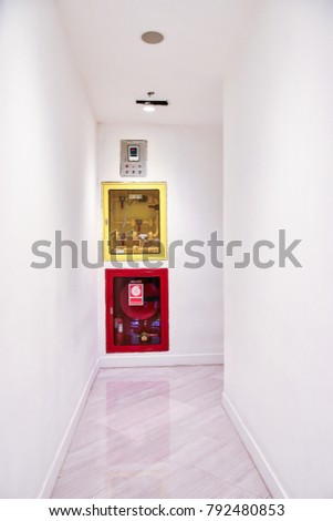 Fire Hoses Packed Inside Of Red And Yellow Emergency Box At The Wall. Red And Yellow Fire Hose Cabinet And It Equipment Hanging On The Wall. Image For Templates, Placards, Banners, Presentations.