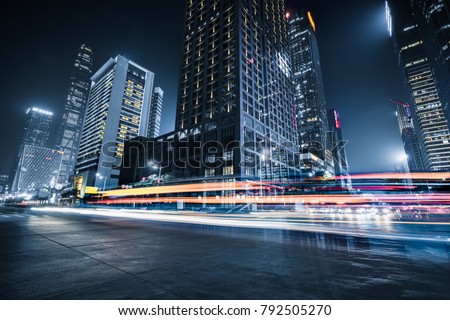 the light trails on the modern building background Royalty-Free Stock Photo #792505270