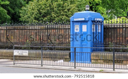A blue police telephone box on the street in Glasgow, Scotland, United Kingdom, often associated with the science fiction television program Doctor Who Royalty-Free Stock Photo #792515818