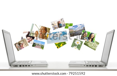 two laptops are sharing photos by air. All flying photos you can find at my portfolio. Royalty-Free Stock Photo #79251592