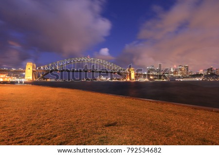 Sunset at Sydney Harbour Bridge looking from blue point bay toward to Sydney city CBD, Syd, Australia 