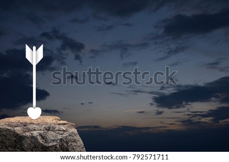 Love heart dart Icon on rock over sunset sky, Valentines day concept