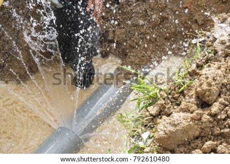 Splatter of water from broken pipe Royalty-Free Stock Photo #792610480