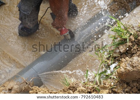 Splatter of water from broken pipe Royalty-Free Stock Photo #792610483