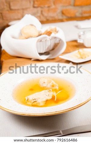 Dumplings in broth with an egg yolk served in a restaurant