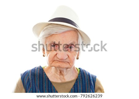  Picture of a disabled senior woman sitting indoors and  wearing a hat