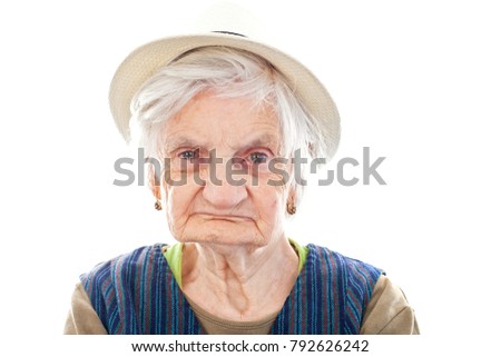  Picture of a disabled senior woman sitting indoors and  wearing a hat