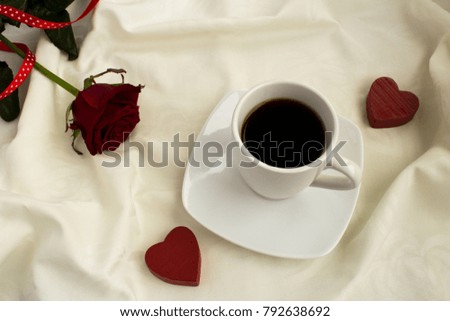 Coffee, two hearts and rose  in the white bed