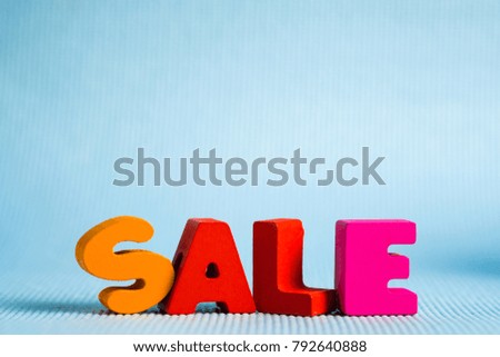 Sale colorful wooden text on blue background with copy space, shopping discount and marketing concept idea. template for add text or photo.