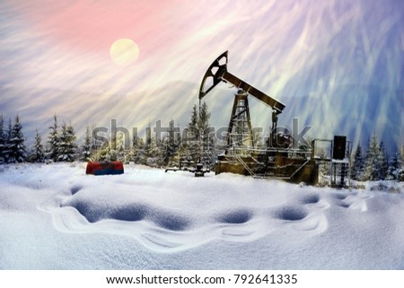 Electric oil pumping in a severe winter frost and snowstorm in Ukraine, a magic colorful scene with the Moon and blizzard in the background, New Year and Christmas theme
