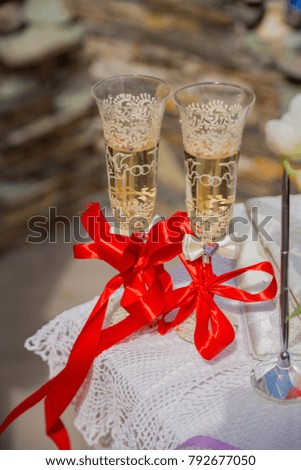 glasses with champagne and ribbon red