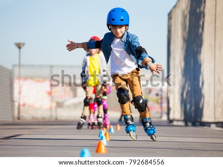 Young inline skater practicing forward slalom