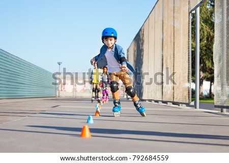 Happy inline skater slaloming at skate park