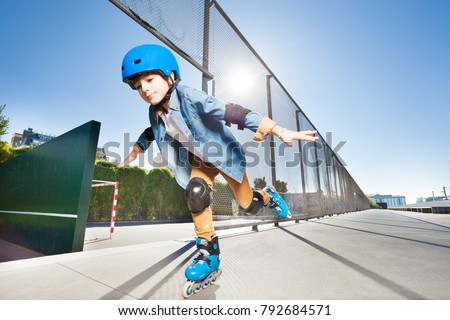 Boy in roller blades doing tricks at skate park