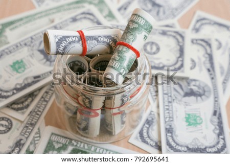 US dollars banknotes in the glass bottle