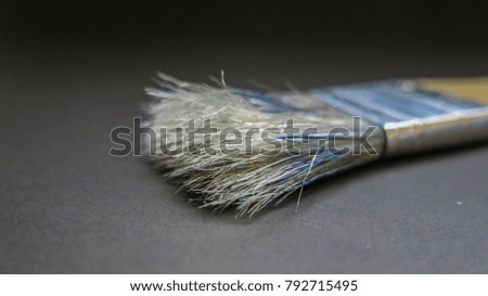 Close up dirty paint brush isolated on black background, blank copy space to edit text