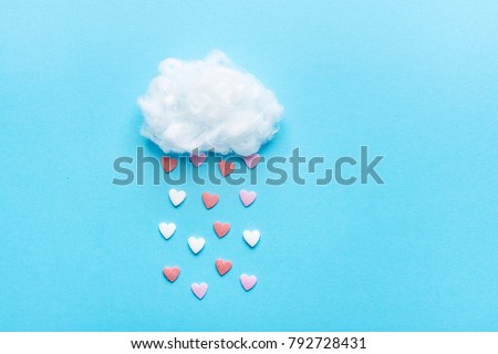 Cotton Ball Cloud Rain Sugar Candy Sprinkle Hearts Red Pink White on Blue Sky Background. Applique Art Composition Kids Style. Valentines Love Charity Concept. Greeting Card Poster Copy Space