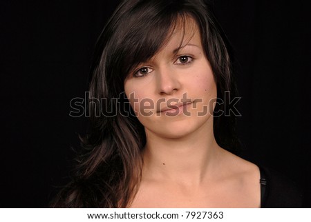 Young beautiful woman portrait on black background