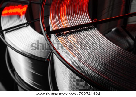 welding wire, stainless steel, on a black background Royalty-Free Stock Photo #792741124
