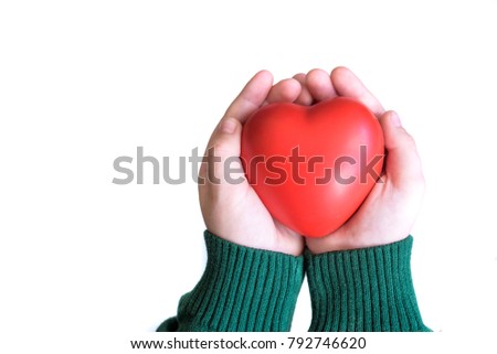 Baby hold red color heart in child hands, love and health concept.