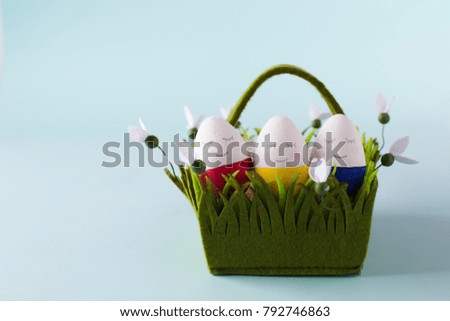 funny, colorful, lovely and kind Easter eggs - painted with hands, lie in a basket. Background for Easter greetings, concept