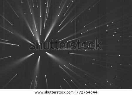 Light rays through small holes in a dark metal space Royalty-Free Stock Photo #792764644