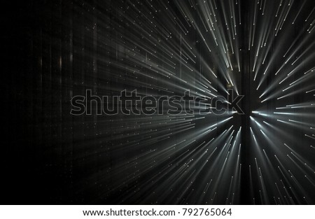 Light rays through small holes in a dark metal space Royalty-Free Stock Photo #792765064