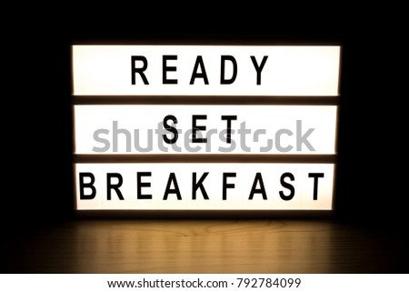 Ready set breakfast light box sign board on wooden table. 