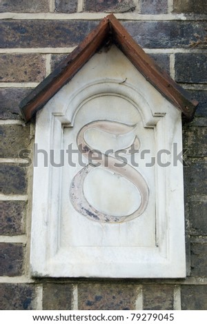 A Victorian arts and crafts style number eight outside a London building.