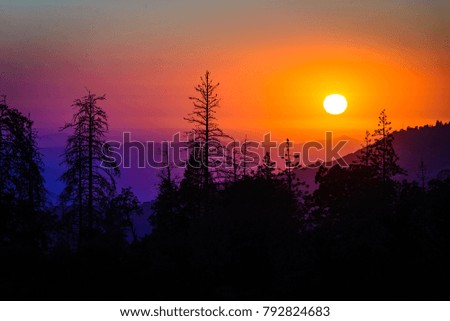 Rainbow Sunset Behind Mountains and Forest 