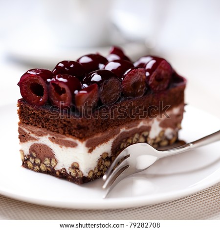 Chocolate Cake with Sour Cherries. Piece of Cake on a Plate. Sweet food. Sweet dessert. Close up.   Royalty-Free Stock Photo #79282708